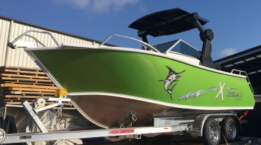 A 5.8m Formosa XBowrider in green, white and black.