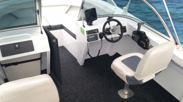 Bowrider, showing drivers position and many embedded electronics including marine radio and sounder