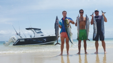 Happy Mates with great catches alongside their 620 Tomahawk Half Cabin