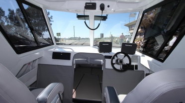 Cabin of aluminum boat with electronics and canvas cabin enclosure
