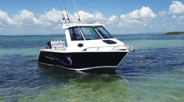 Half Cabin aluminum plate boat on clear water in fair weather